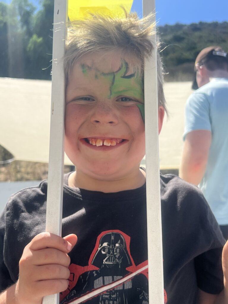 A kid showing off his face paint