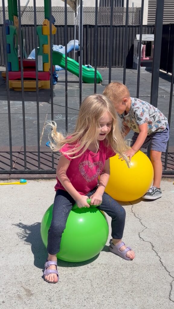 Kids on bouncy balls in the play zone